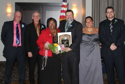 RVAC lifetime achievement award recipient Betty Harris with RVAC board members, from left, Ron Rowe, Keith Lewin, Bruce Talmage and Kim Pokorney, and RVAC Chief Joseph Oliver at the corps' 35th Anniversary Installation Dinner Feb. 22 in Riverhead. (RiverheadLOCAL photo by Peter Blasl)