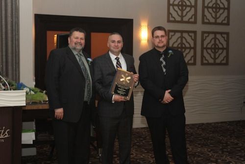 RVAC board president Bruce Talmage, left, with 15-year member Alexander Caceres and Chief Joseph Oliver.