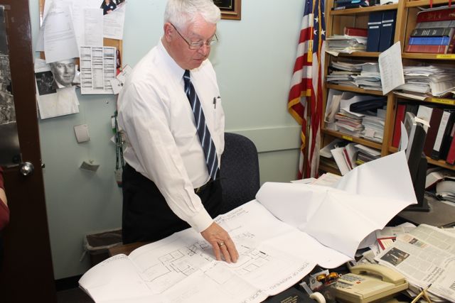 Justice Allen Smith reviews armory building construction plans in his office Monday afternoon. (RiverheadLOCAL photo by Denise Civilettti)