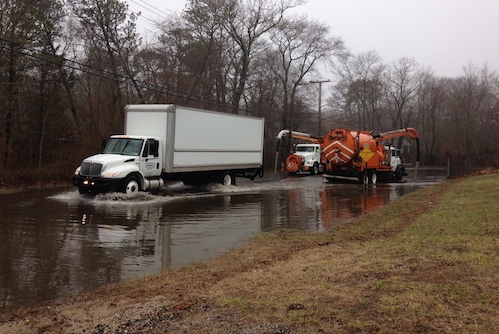 Riverhead highway crews pump water off Middle Road this morning.  (RiverheadLOCAL photo by Peter Blasl)