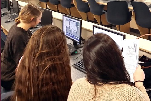 Pictured are students (L-R: Kaity Talmage, Faye Swett, Melissa Pressler) measuring their selected building on Google Earth and carrying out energy production calculations of their conceptual solar array. (Kim Gutherie is also on the team, however, she is not pictured.)