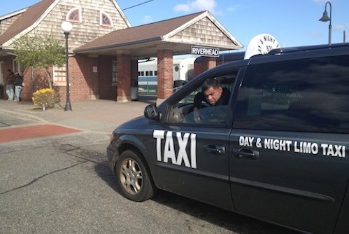 A Day and Night Taxi vehicle waiting at the Riverhead train station last summer. (Photo: Denise Civiletti)
