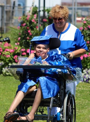 Nancy Reyer pushes her son Michael Hubbard in his wheelchair during the Riverhead High School 2014 commencement exercises. (Photo: Denise Civiletti)