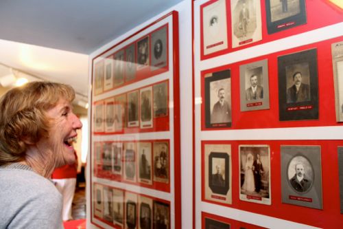 Pendzick admires photos of Polish immigrants taken between 1880s and early 1900s as a way to ID Riverhead Savings Bank's immigrant customers.