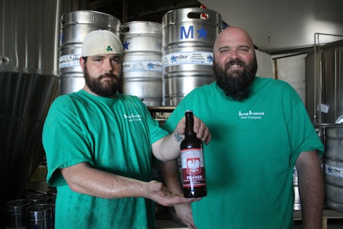 Fred Keller (left) and Dan Burke with one of only 300 bottles of their Polish Town Pilsner. (Photo: Peter Blasl)