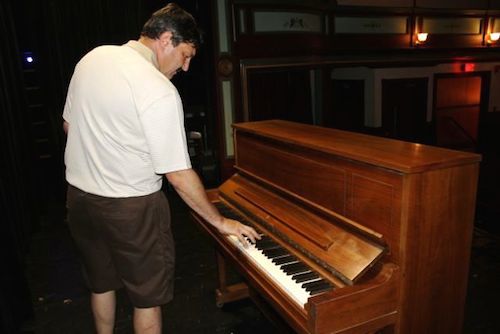 Bob Barta touches the keys of his old friend's Steinway. (Photo: Peter Blasl)