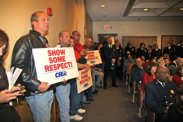 Civil Service Employees Association members, joined by area volunteer firefighters, protest during a 2010 town board meeting after the supervisor proposed a 2011 operating budget that cut 13 positions, including one of the town fire marshals. (File photo: Peter Blasl)
