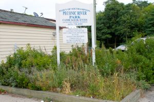 The overgrown and littered entrance to Southampton Town's Peconic River Park on Peconic Avenue, adjacent to the building where the Riverside Rediscovered office is located on Peconic Avenue Sept. 9.