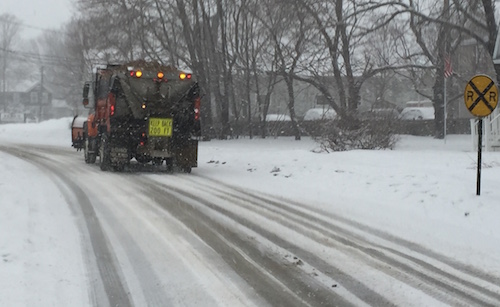 Riverhead Highway Department truck spreading salt-sand on Sweezy Avenue yesterday morning as snow began to fall. (Photo: Peter Blasl