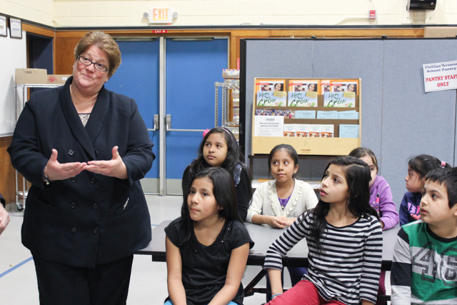 Phillips Avenue Elementary School principal Debra Rodgers talks to local officials and fourth grade students about the district's first in-school food pantry. Photo: Katie Blasl