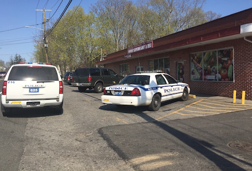 Riverhead Police vehicles outside the West Main Street grocery store across from where a man was mugged at about 3:30 p.m. May 4. Photo: Peter Blasl
