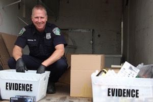Riverhead Police Officer Rick Anderson weighing and packaging 102 pounds of drugs collected at the Take-Back Drive-Through Event.