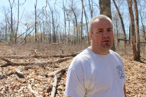 Flanders Fire Chief Joe Petit in the woods behind the firehouse in early May.