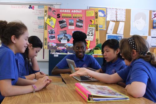 A group of sixth graders discuss possible solutions to make the road safer for students. Photo: Katie Blasl