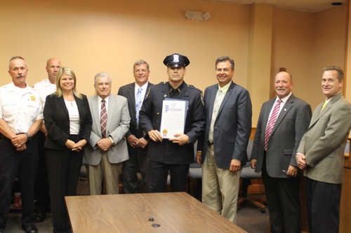 Riverhead Police Officer Tim Murphy, center, was honored by County Legislator Al Krupski yesterday for making more DWI arrests in 2014 than any other cop on the Riverhead PD. Photo: Denise Civiletti