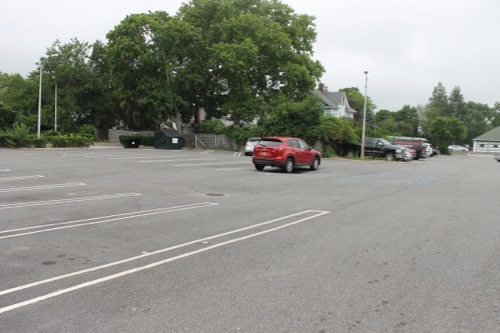 The parking lot behind the former Riverhead Project, which the town sublet from the tenant and spent $65,000 to repave, together with the adjoining lot to its east (in background). Photo: Denise Civiletti 