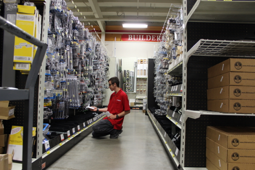 Spencer stocks shelves and helps customers three days a week at Riverhead Building Supply, where he started working in February. Photo: Katie Blasl