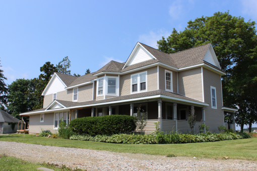 The two-story farmhouse, when completed, will have between 10 to 12 bedrooms, several large bathrooms, two kitchens, a library and ample living space. Photo: Katie Blasl