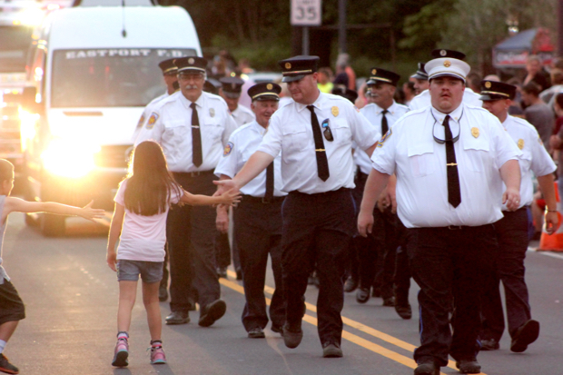 More than a dozen fire departments marched along Main Road in Jamesport during last night's parade. Photo: Katie Blasl