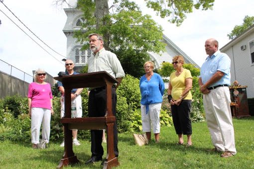 Reverend Sean Murray asked for the community's support while the church makes repairs in a press conference this morning. Photo: Katie Blasl
