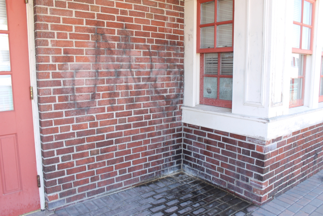 The urine-stained wall and sidewalk of the vacant station building on Aug. 10. Photo: Denise Civiletti