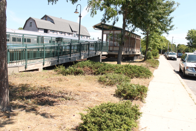 Following complaints by town council candidate Neil Krupnick and inquiries by a reporter, workers mowed the weeds and removed dead bushes near the platform. Photo: Denise Civiletti