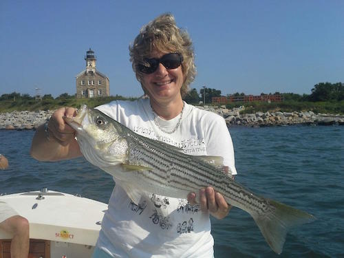 Helen Wedlock with a striper caught fishing with captain Rob Thompson. Photo: Rob Thompson 