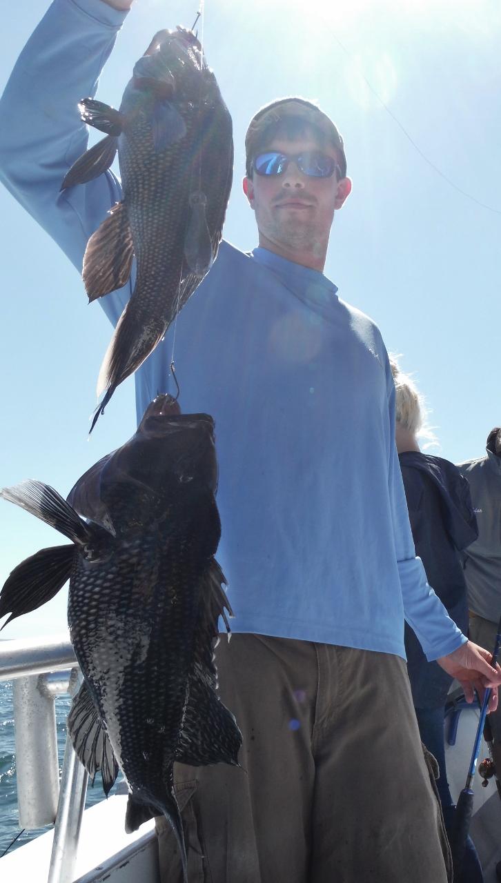 Jordan with a double header of sea bass aboard the Brooklyn Girl. 