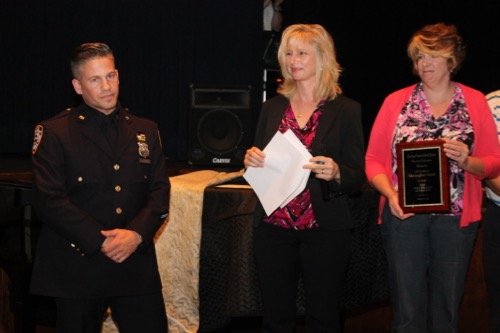 Police Officer Christopher Canales with school board president Sue Koukonas and board member Amelia Lantz. Photo: Denise Civiletti