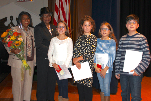 From left to right: Joan Brown-Smith, who was engaged to Langhorn at the time of his death; Mary Langhorn, his mother; and sixth grade essay contest winners Alexandra Goodale, Haylie Esposito, Olivia Goodale and Dominic Geraci. Photo: Katie Blasl