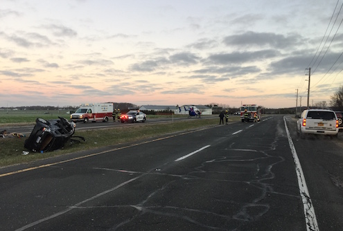 The driver of a westbound Honda spun out on an icy road and lost control of his vehicle, which overturned in the median. 