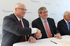 Mitchell and Dowling signed a merger agreement today at Peconic Bay Medical Center. Photo: Katie Blasl
